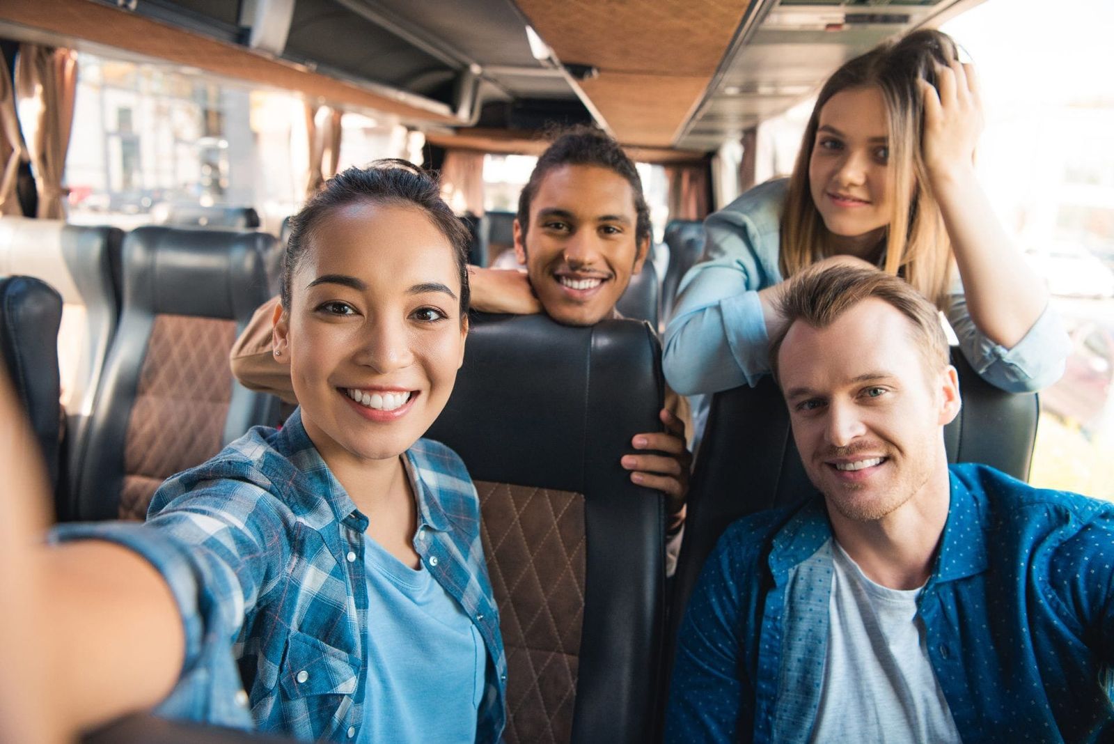 Smiling business team enjoying a comfortable journey with West London corporate minibus hire service