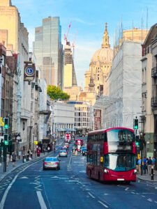 Red buses in busy London street, symbolizing travel ease with West London Minibus Hire for luxury and executive transport.