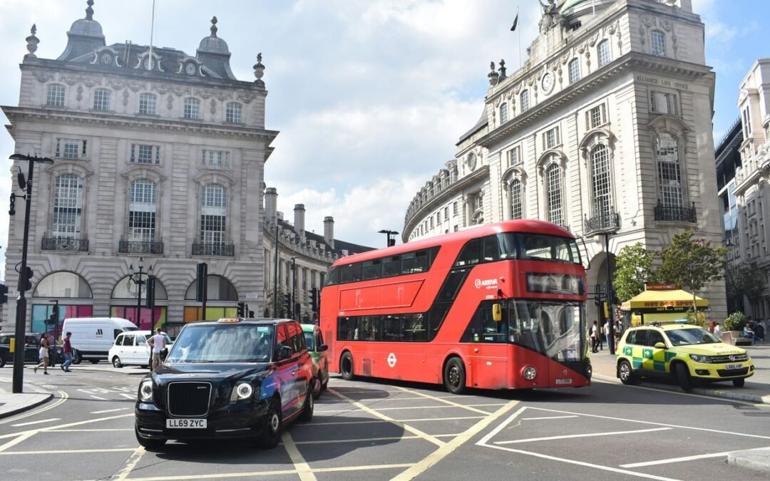 a red double decker bus driving down a street