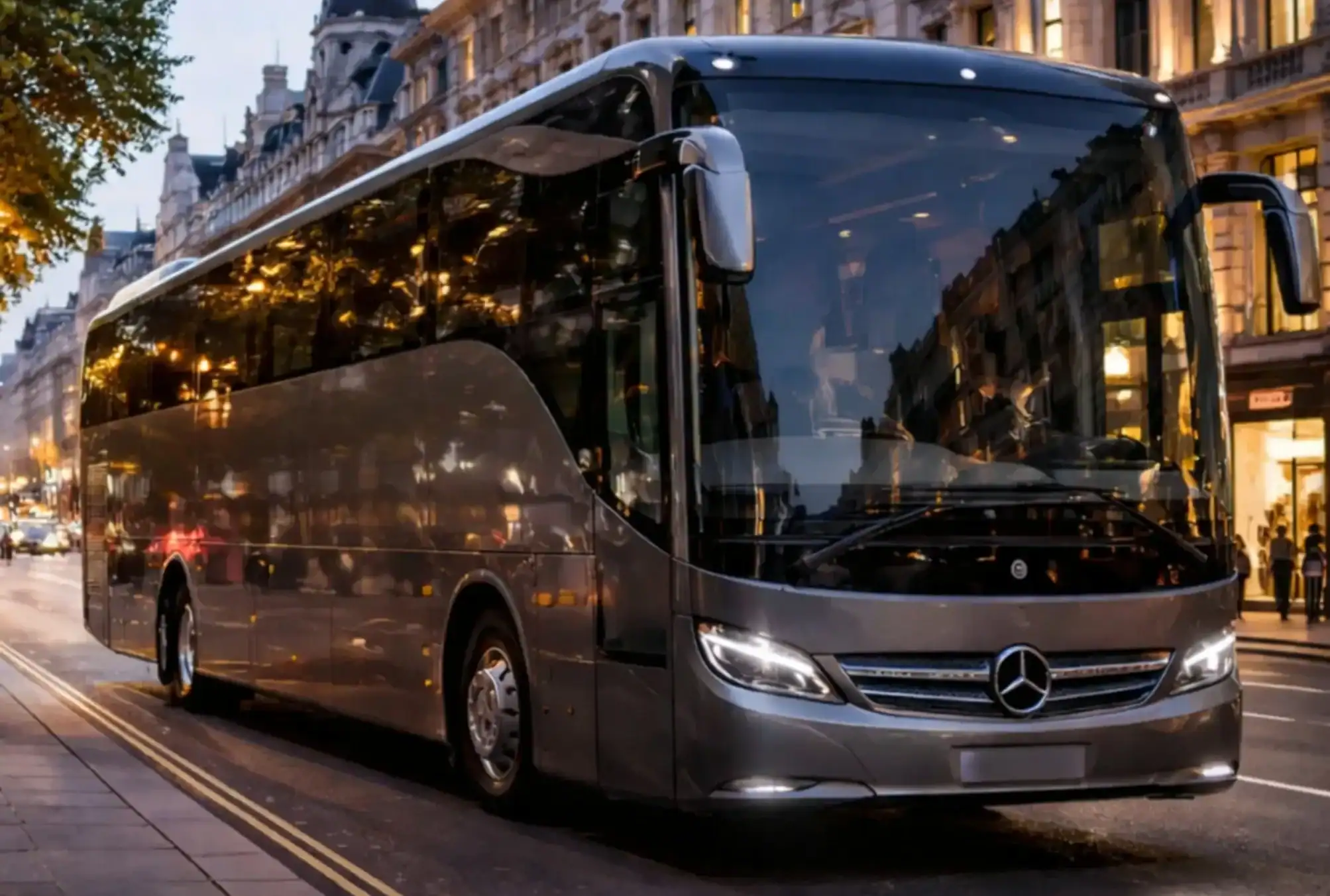 55 seater coach hire for large group travel parked on a city street in the evening